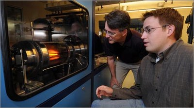 Timothy D. Sands (left),director of Purdue's Birck Nanotechnology Center in Discovery Park, and a graduate student operate a "reactor" in work, which deposits gallium nitride on silicon at  temperatures of about 1,000 degrees Celsius.