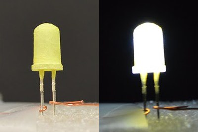 An LED coated with a yellow “phosphor” is shown turned off (left) and then turned on (right). This “green” LED is inexpensive and provides warm white light (Credit: Zhichao Hu, Ph.D.)