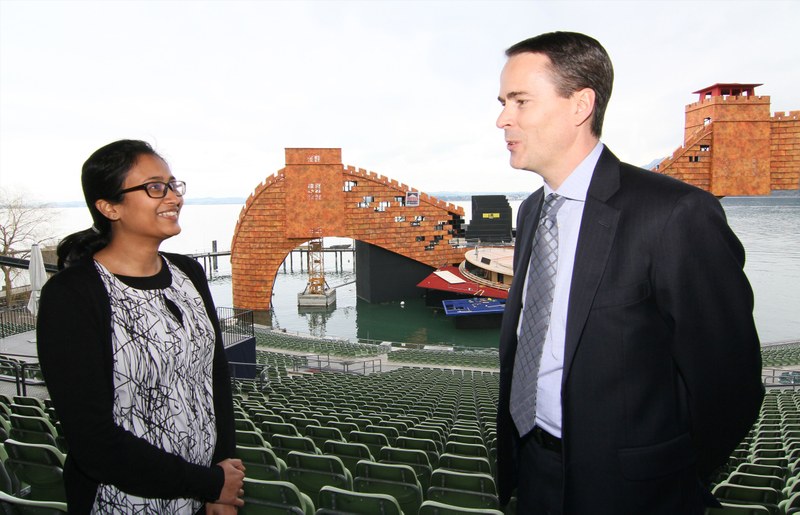 Daniel Doxsee and Amrita Prasad talking in front of the floating stage with Turandot’s “Chinese Wall”